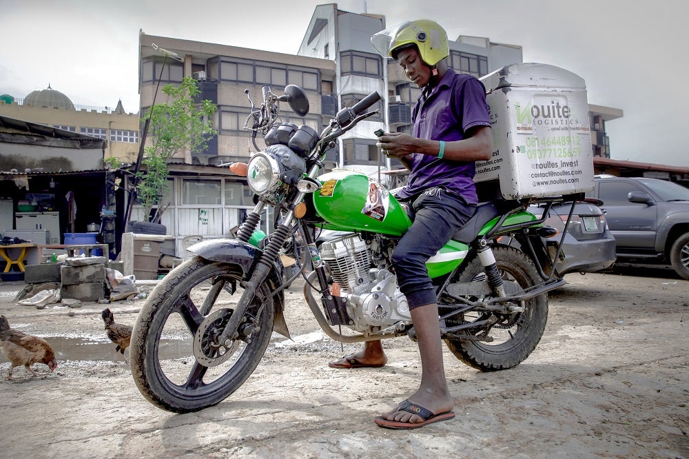 A delivery driver checks his delivery service platform in Lagos, Nigeria.