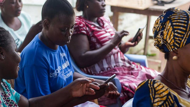 Women looking at their mobile phones.