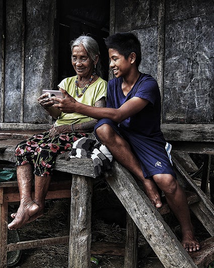 Household uses mobile phone in rural village in the Philippines