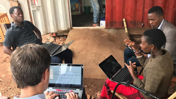 People sitting in a circle for a Fintech startup meeting.