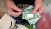 A man counts money in Lebanon