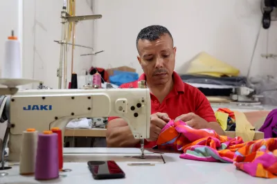A tailor works in his workshop.