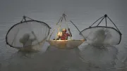 Women in the water in India with fishing nets