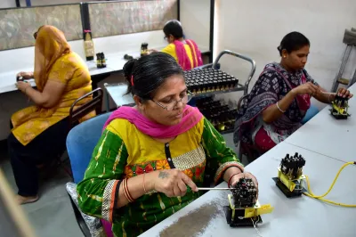 Women work in an assembly line in India