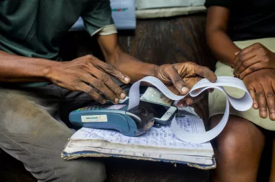 a man is printing a receipt on a handheld device 