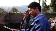A microfinance agent speaks with a customer in the remote highlands of Peru.