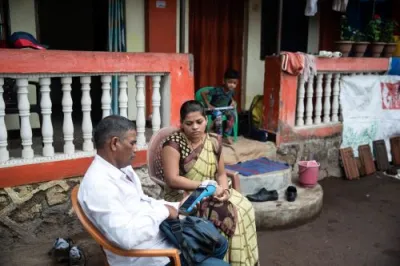 a man and woman seated on chairs with phones