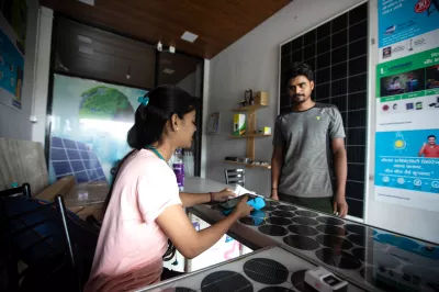 a man interacts with a woman sitting behind a desk at a bank