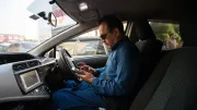 A driver looks at his phone