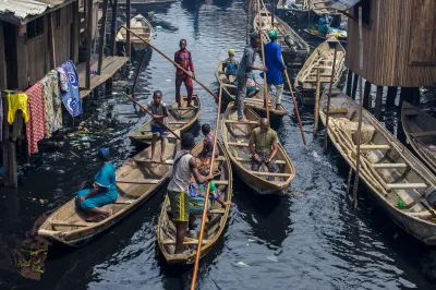 People ride in canoes outside Lagos, Nigeria