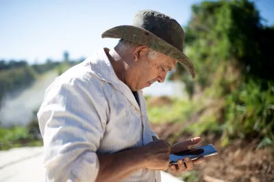A Brazilian farmer looks at his phone