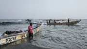Fishermen arrive onto a beach in Dakar, Senegal.