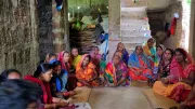 Women sit in a circle for a focus group discussion