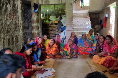 Women sit in a circle for a focus group discussion