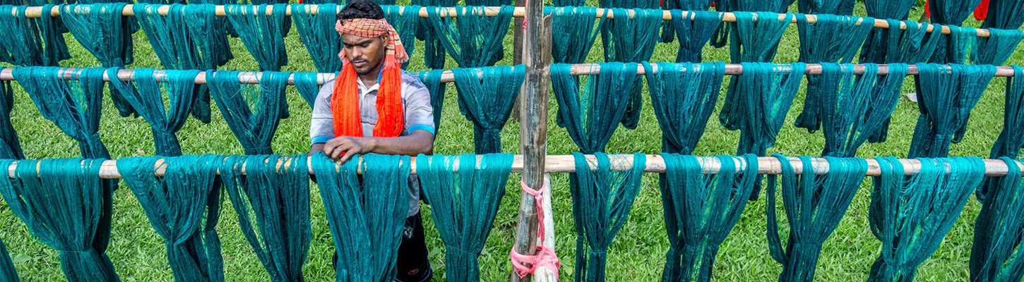 Bangladeshi worker coloring and drying cloth material, Bangladesh. Photo by Sohel Parvez Haque, 2017 CGAP Photo Contest