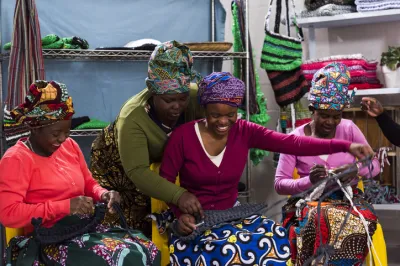 a group of african women learning to knit