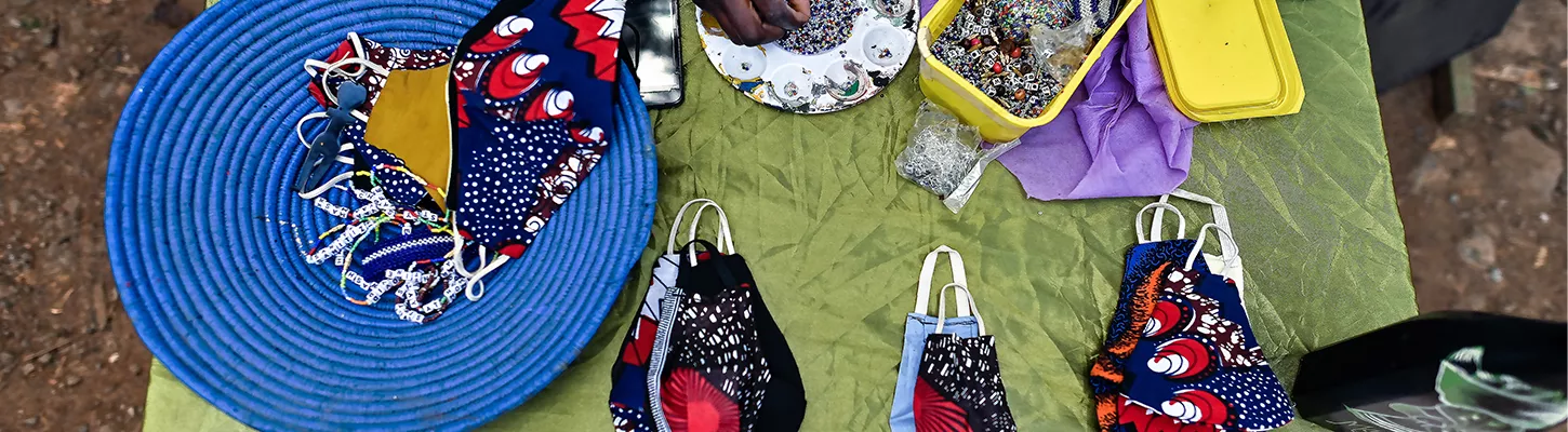 person creating facial masks for protection from covid-19