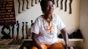 A Ghanian woman sits in her handicraft shop