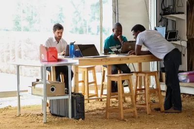 Three employees look at their computers